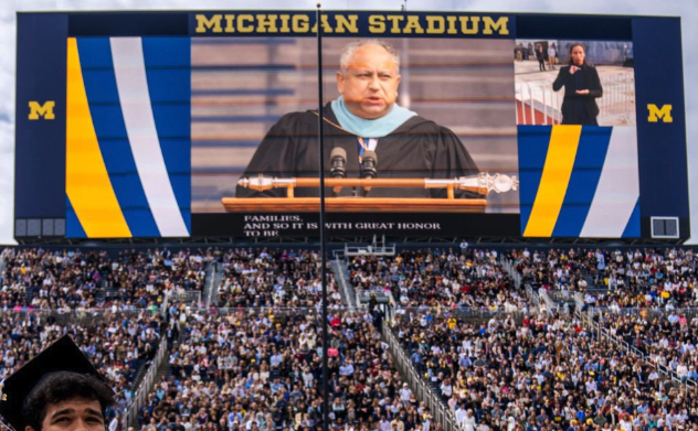 University of Michigan graduates listen to a line of speakers